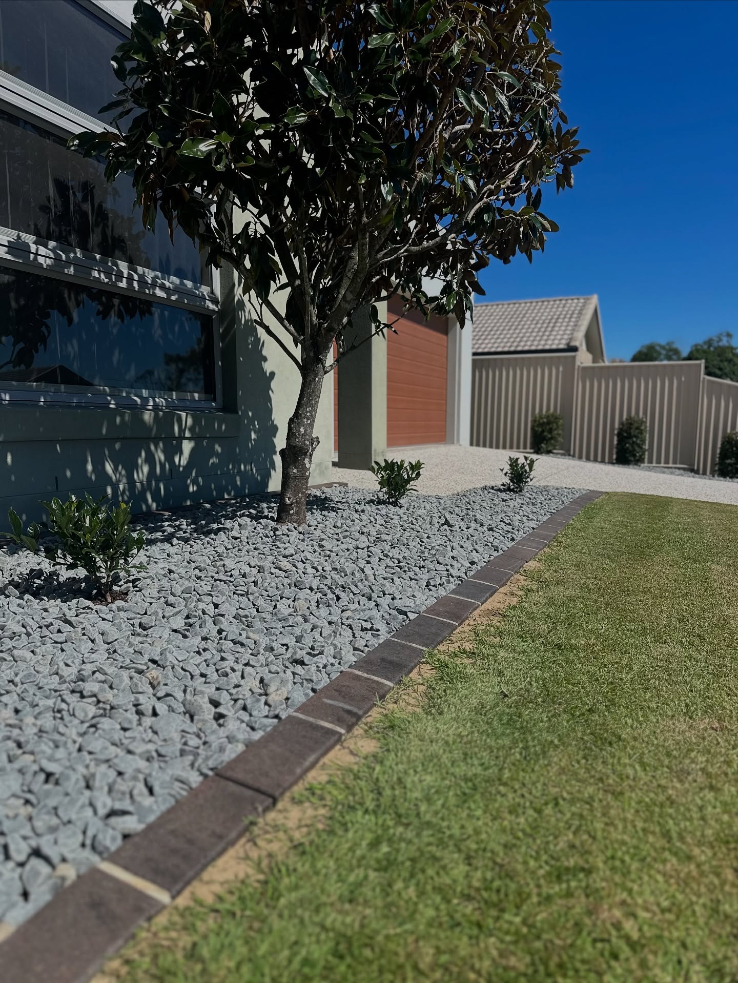 Sandstone paving and a stacked stone retaining wall in a subtropical Brisbane garden